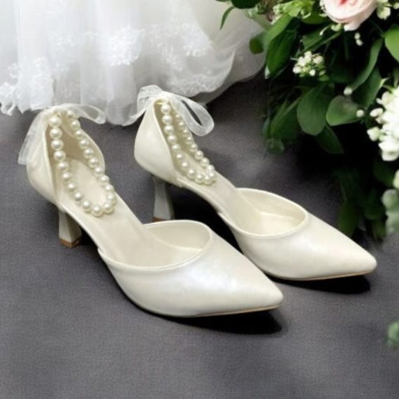 Elegant pearl white bridal heels with 9–10cm comfy heel, ankle ribbon and pearls, perfect for brides, bridesmaids, and special occasions in Beirut Lebanon by White Lily Brides.