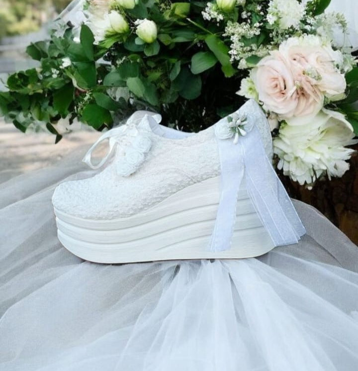 Elegant white bridal sneakers with lace, satin, and floral decorations, featuring a 9-10 cm height with a 4 cm platform, perfect for weddings, dances, and special bridal ceremonies. Beirut Lebanon
