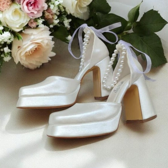 Pearl white bridal heels with comfy 9–10 cm block heel and ankle pearls, perfect for weddings, bridesmaids, graduations, and baptisms – by White Lily Brides, Beirut Lebanon.