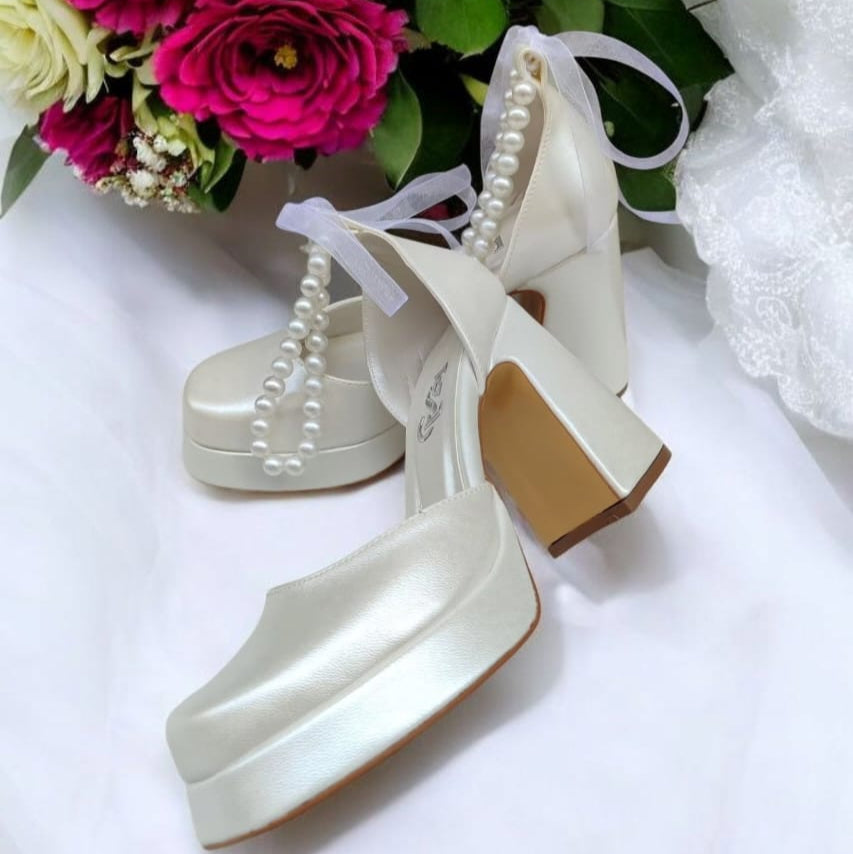 Pearl white bridal heels with comfy 9–10 cm block heel and ankle pearls, perfect for weddings, bridesmaids, graduations, and baptisms – by White Lily Brides, Beirut Lebanon.