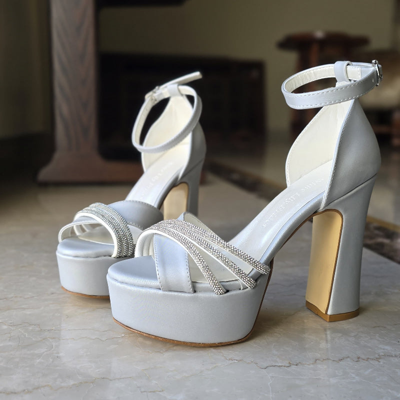 Silver color heel is crafted in satin fabric with shimmering rhinestone straps, making them ideal for weddings, bridesmaids, graduations, and special events.