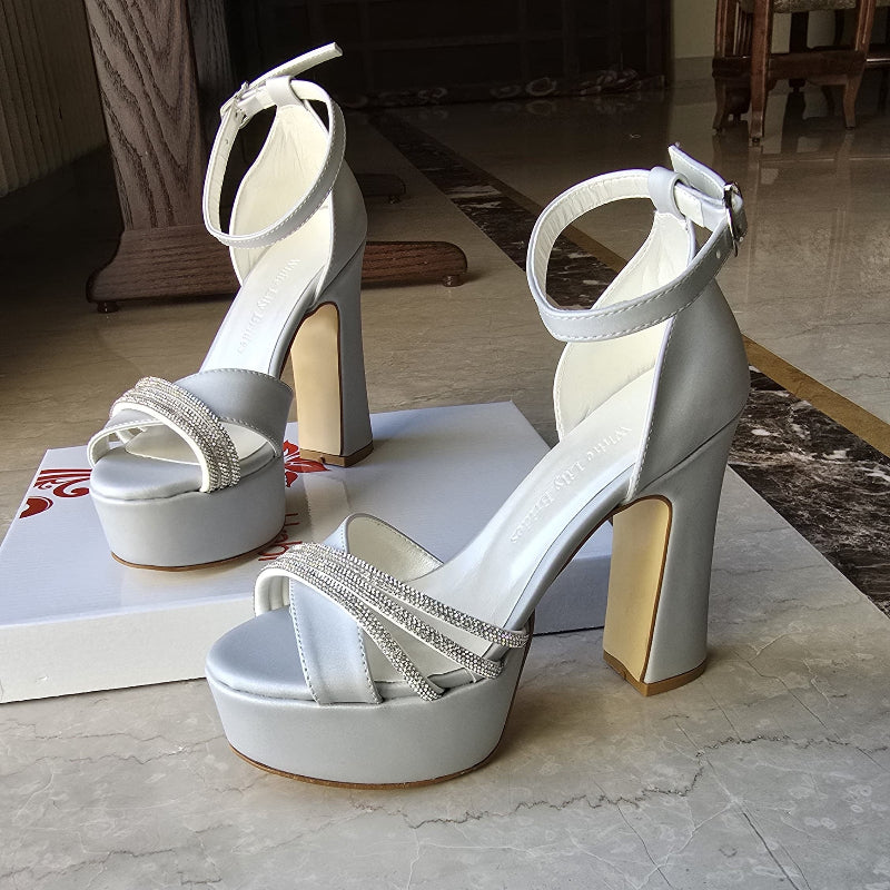 Silver color heel is crafted in satin fabric with shimmering rhinestone straps, making them ideal for weddings, bridesmaids, graduations, and special events.