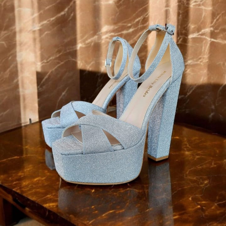 Silver high block heel bridal shoe (15–16cm) with ankle strap, displayed on a marble table. Perfect for brides, bridesmaids, and special occasions in Beirut and across Lebanon.