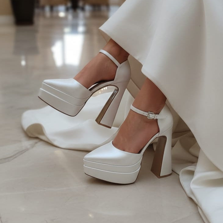 White platform high heels worn by a person in an indoor setting