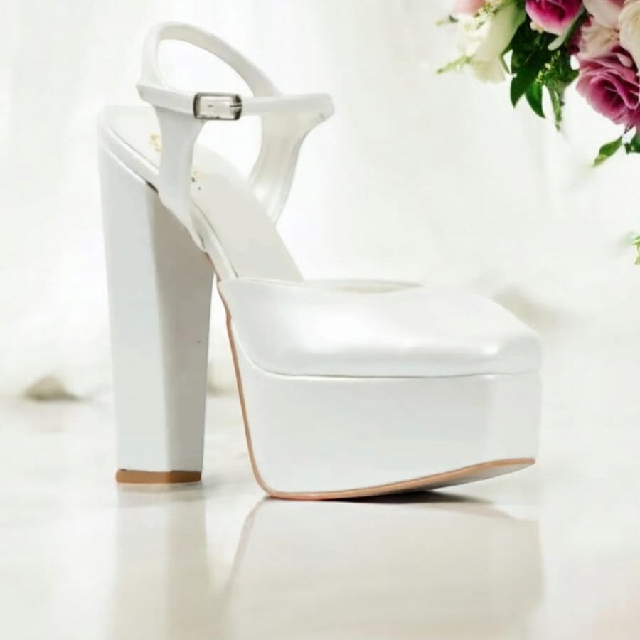 White high-heeled shoes on a white background with flowers.