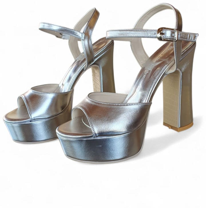 Silver platform high heels on a white background
