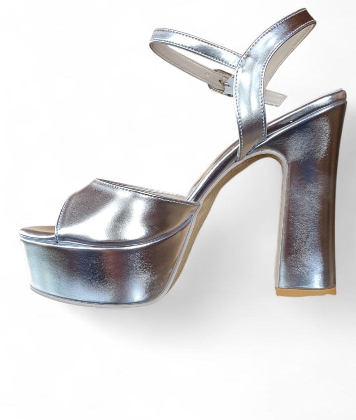 Silver high-heeled platform shoes on a white background