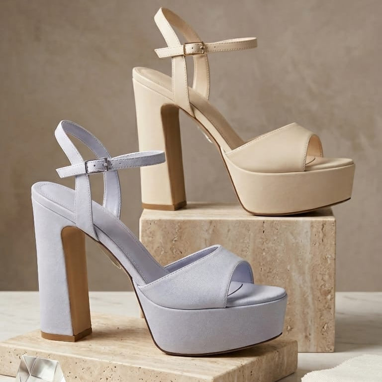 Two high-heeled shoes on stone blocks with a neutral background and text 'The New Essentials'.
