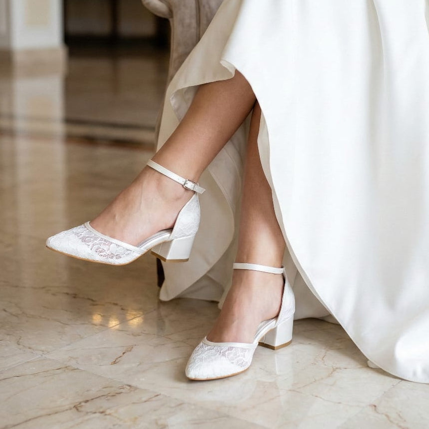 Closed toe d'orsay style bridal heels with block heel and ankle strap in ivory white.