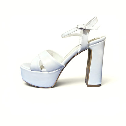 12 cm A single white platform sandal with a high block heel, crisscross front straps, and an ankle strap with a buckle, shown against a plain white background.