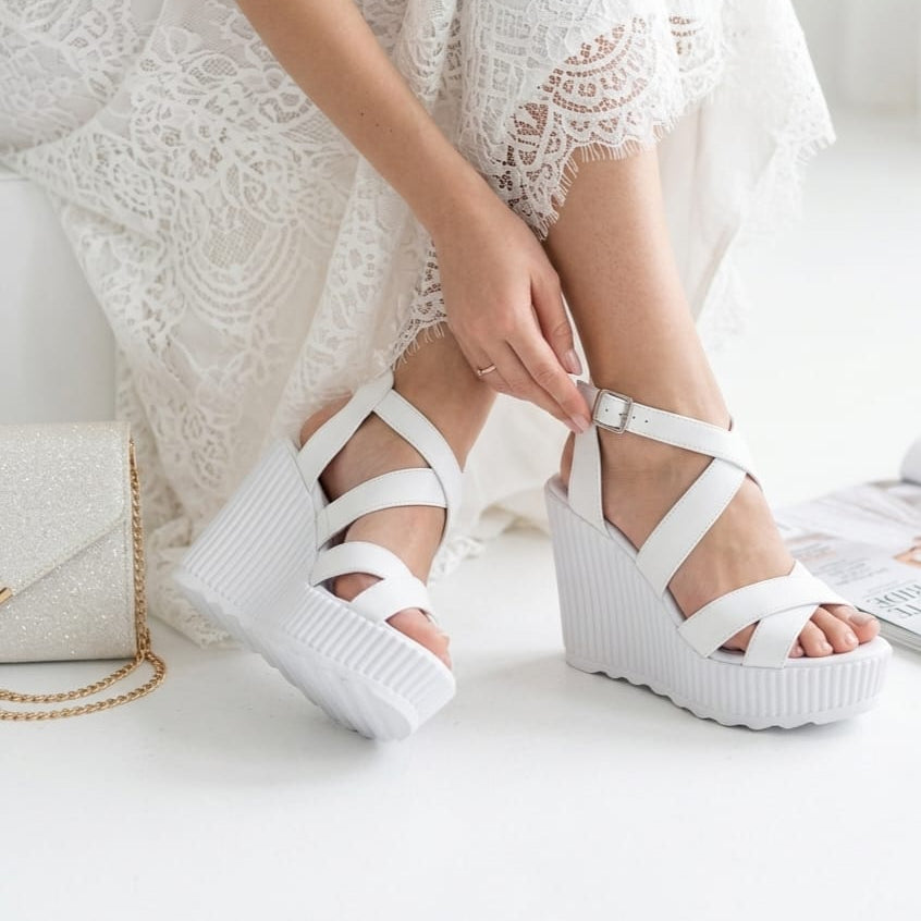 12 cm White platform sandals worn with a white lace dress on a light background