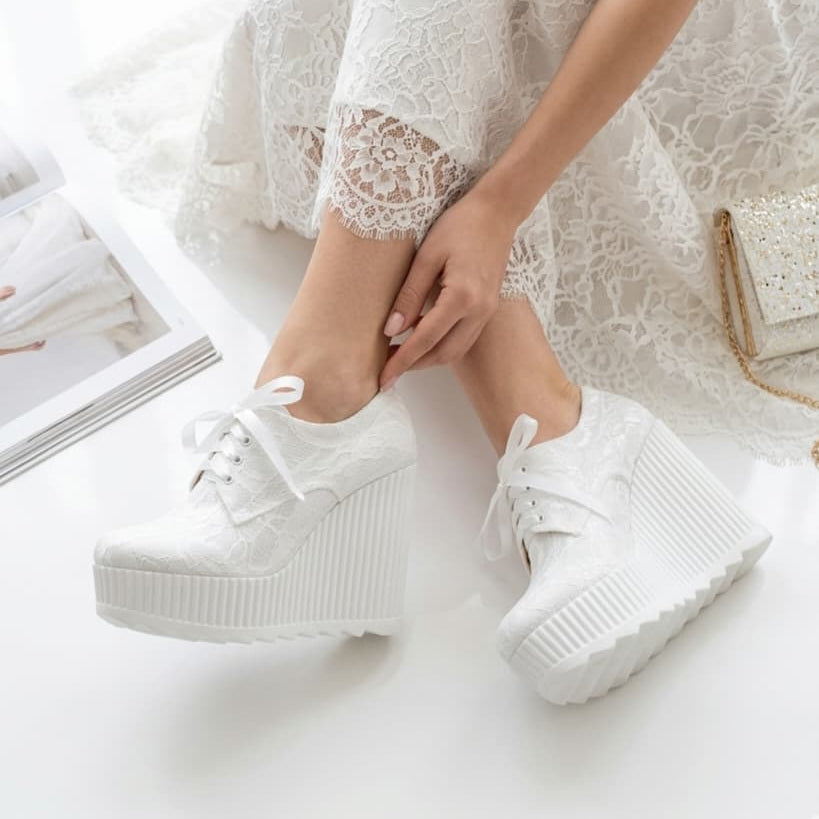 12 cm White sneakers worn with a wedding dress on a light background in Beirut Lebanon