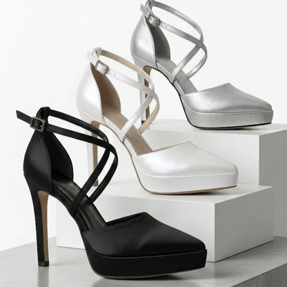 Black, silver, and white high-heeled platform shoes on a white background