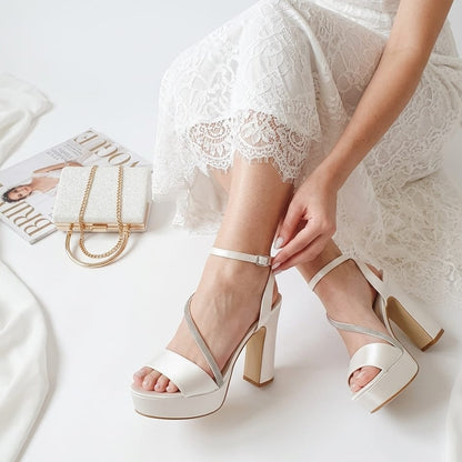 Bridal Pearl White high-heeled sandals being worn with a white lace dress on a light background in Beirut Lebanon