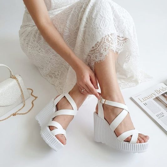 Bride wearing white platform Bridal sandals on a light background in Beirut Lebanon