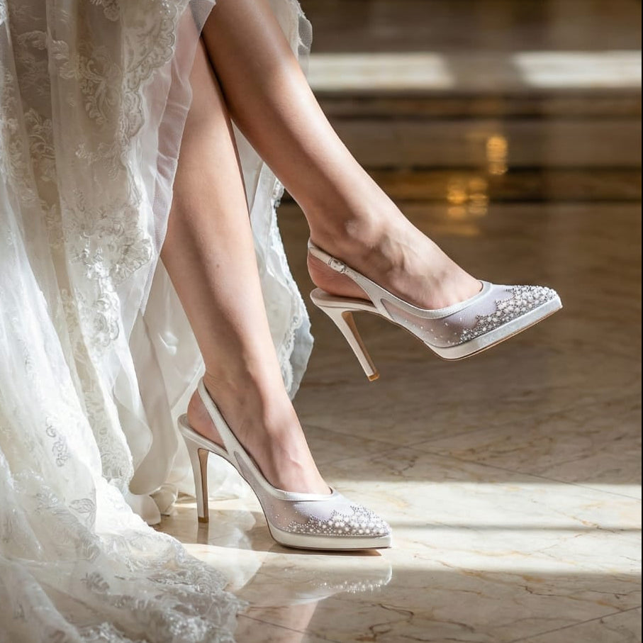 Bride with high-heeled lace shoes sitting on a chair.