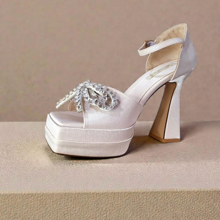 champagne  platform high heel shoe with a crystal bow embellishment and ankle strap