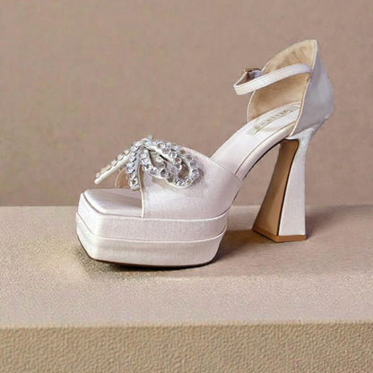 champagne  platform high heel shoe with a crystal bow embellishment and ankle strap