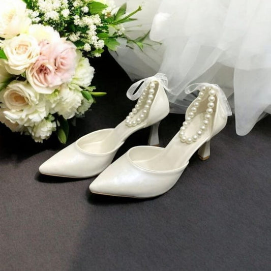 Elegant pearl white bridal heels with 9–10cm comfy heel, ankle ribbon and pearls, perfect for brides, bridesmaids, and special occasions in Beirut Lebanon by White Lily Brides.