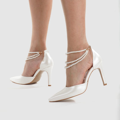 Elegant white bridal heels featuring a triple strand pearl strap and 8cm heel for wedding and formal wear. Beirut Lebanon