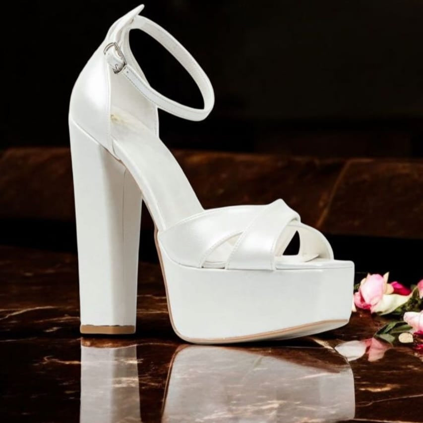 Pearl White high-heeled Bridal shoes on a reflective surface in Beirut Lebanon