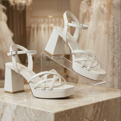 Pearl White high-heeled sandals on a marble surface with a blurred background in Beirut Lebanon