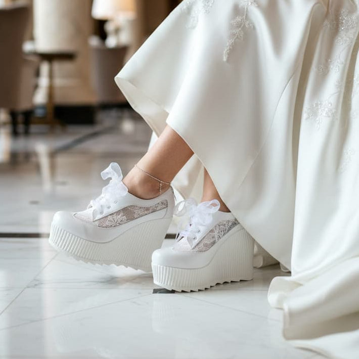 Person wearing a white wedding dress and platform Bridal Sneakers shoes in an elegant indoor setting. Lebanon