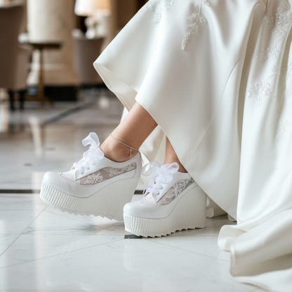 Person wearing a white wedding dress and platform Bridal Sneakers shoes in an elegant indoor setting. Lebanon