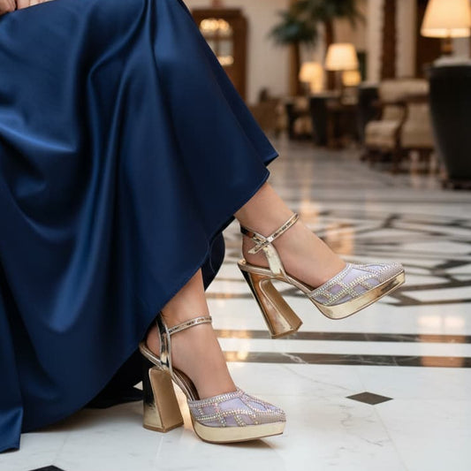 Gold high-heeled shoes with rhinestone embellishments