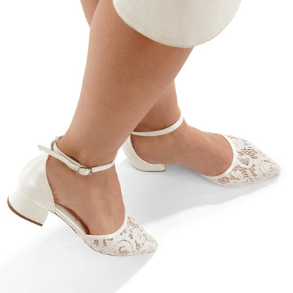White lace shoes worn with white pants on a white background