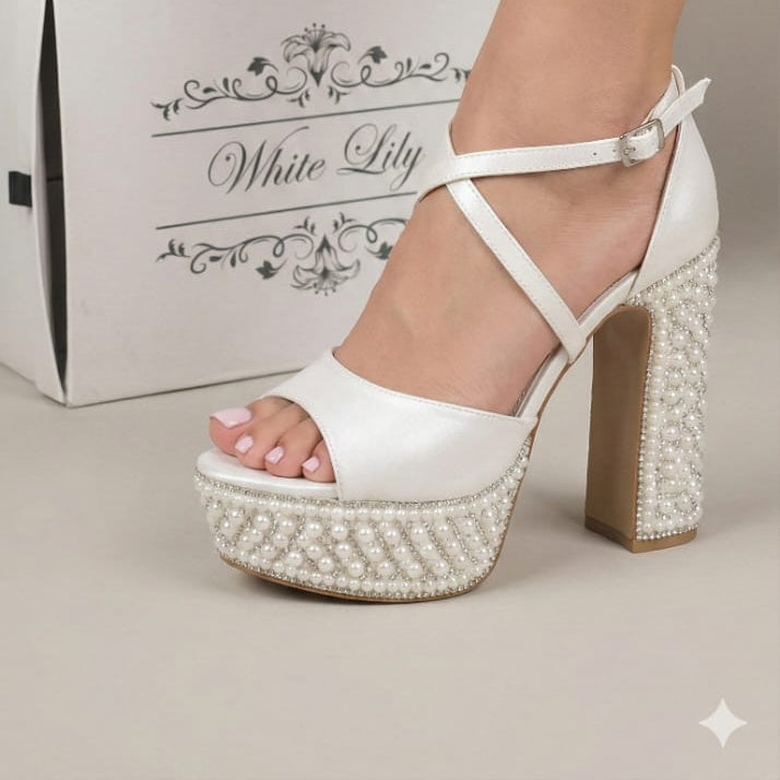 Pearl White high-heeled sandals with pearl embellishments on a neutral background