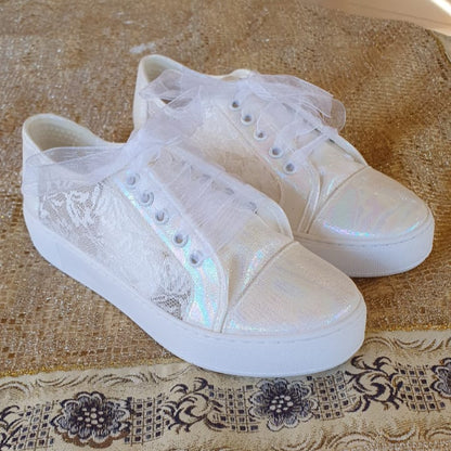 White Lace Bridal  sneakers with lace details on a patterned tablecloth