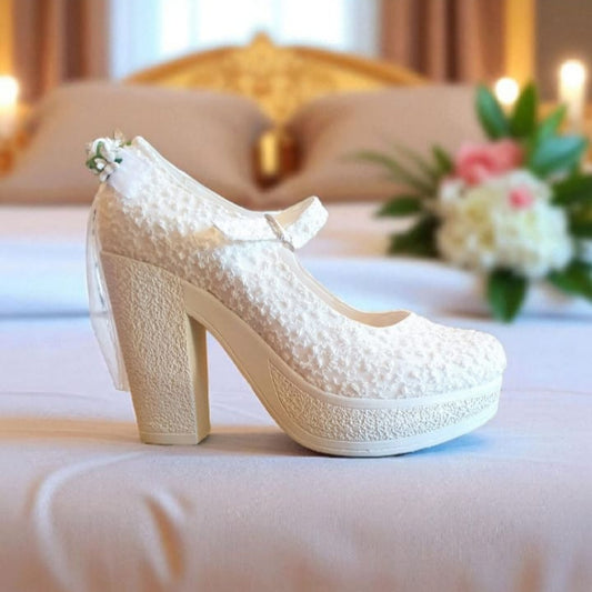 White lace high-heeled shoes  with a blurred background