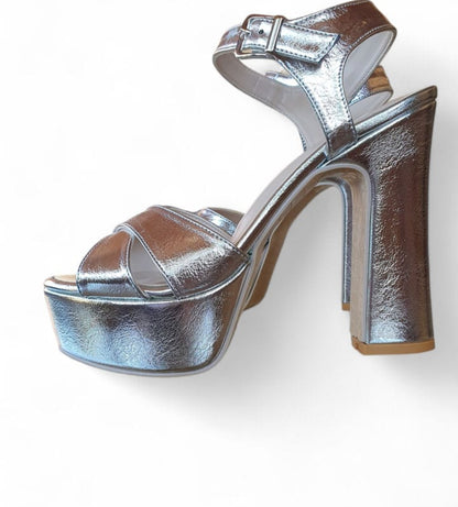 Silver platform high-heeled shoe on a white background