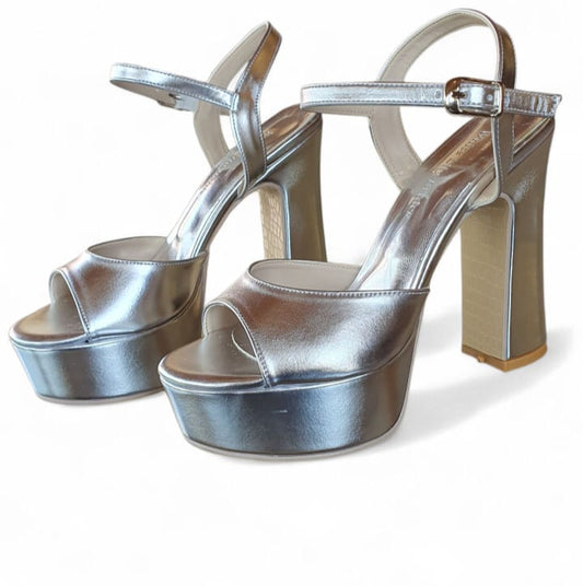 Silver platform high heels on a white background