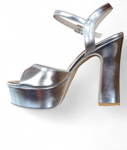Silver high-heeled platform shoes on a white background