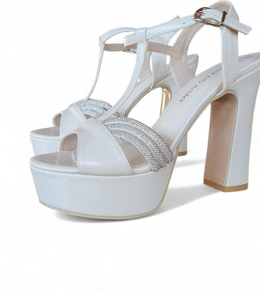 White high-heeled sandals with a platform sole on a white background