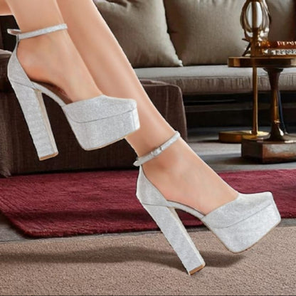Person wearing Silver  high-heeled shoes in a living room setting