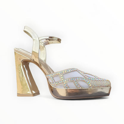 Gold high-heeled shoe with gemstone embellishments on a white background