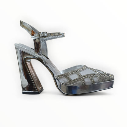 Silver high-heeled shoe with embellishments on a white background