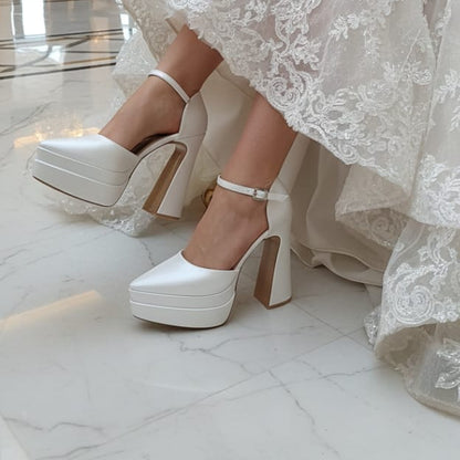 Bride wearing a white lace wedding dress and Bridal platform high heel shoes  
