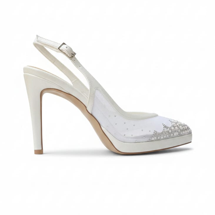 White high-heeled shoe with decorative elements on a white background