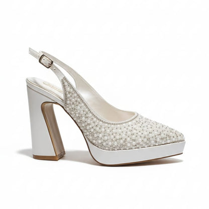 White high-heeled shoe with pearl embellishments on a white background