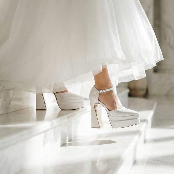 Bride wearing a wedding dress and high-heeled Wedding shoes on a marble floor in Beirut