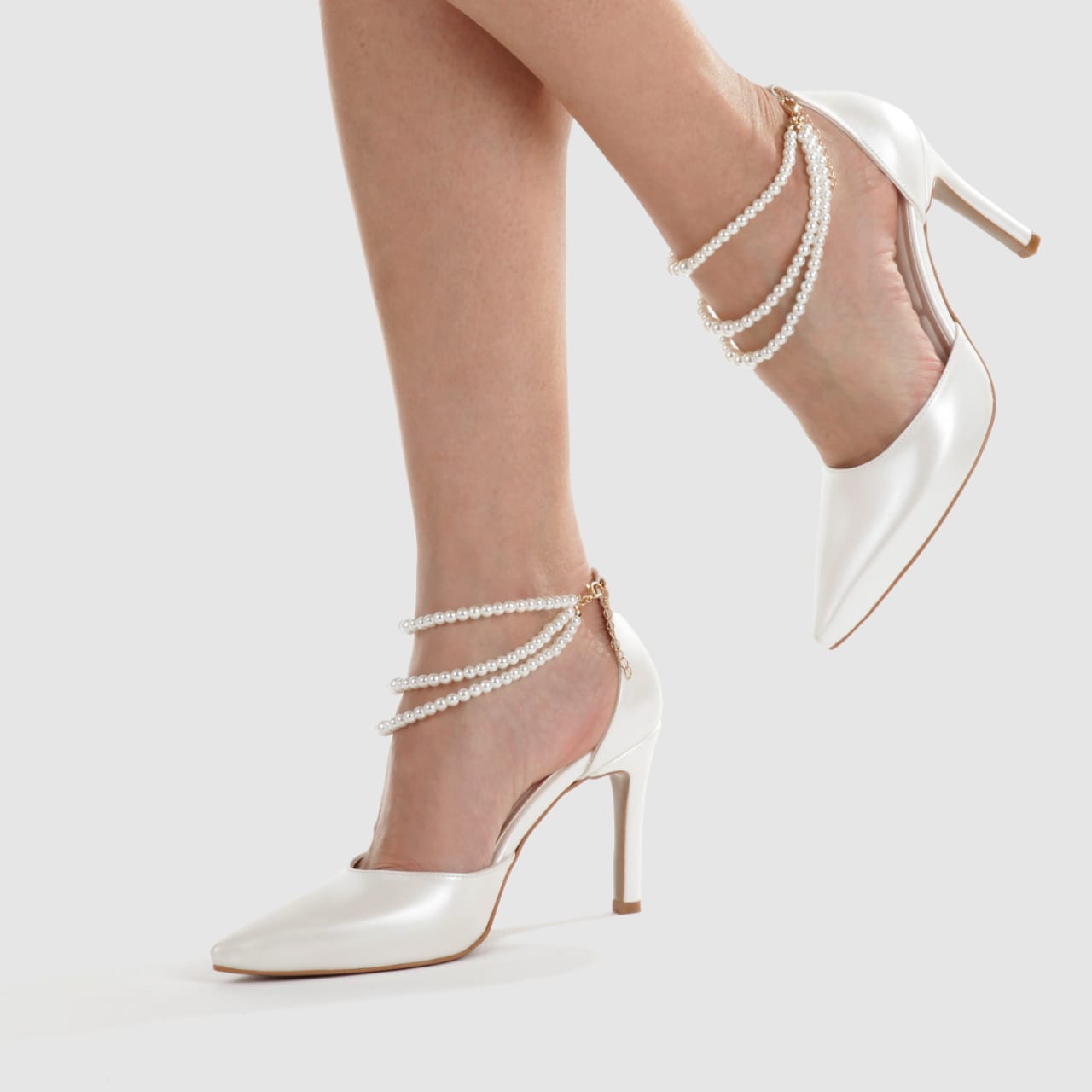 White Lily Brides elegant ivory pointed-toe pumps with a triple-row pearl ankle strap and 8cm stiletto heel. Beirut Lebanon