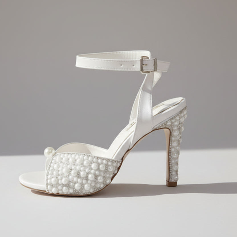 comfortable White high-heeled sandal with pearl embellishments on a white background