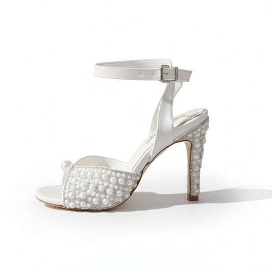 comfortable White high-heeled sandal with pearl embellishments on a white background