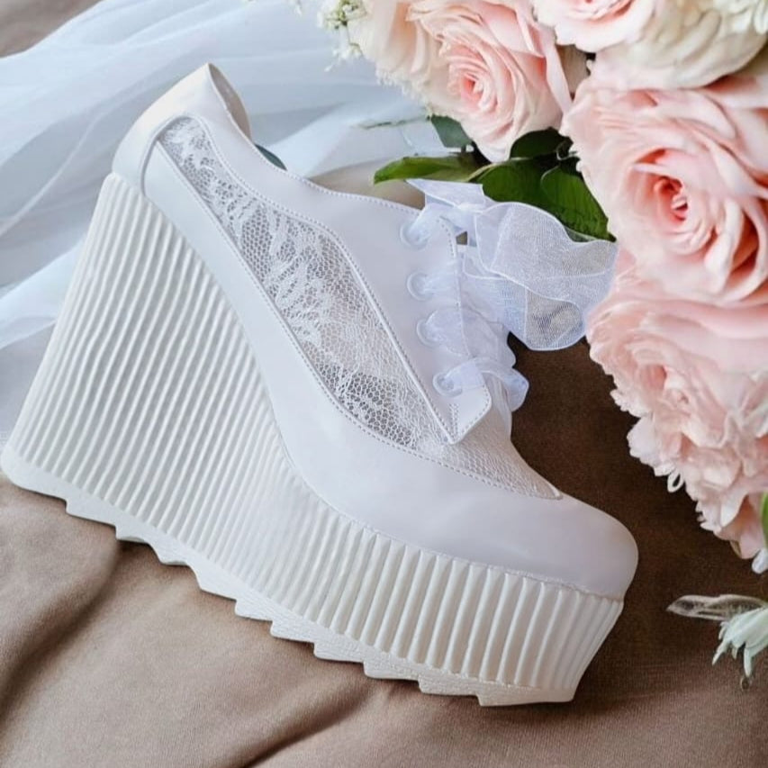White lace-up platform Bridal Sneakers  shoes with a bouquet of pink roses on a neutral background Lebanon