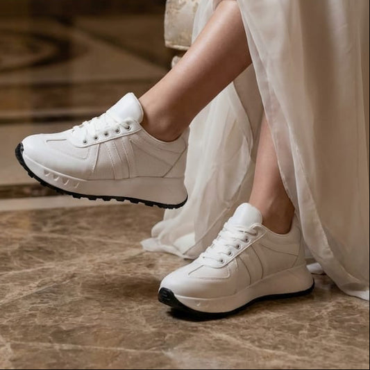Bride wearing white platform bridal sneakers with a luxury wedding dress on a marble floor in a luxury lobby, Beirut, Lebanon.
