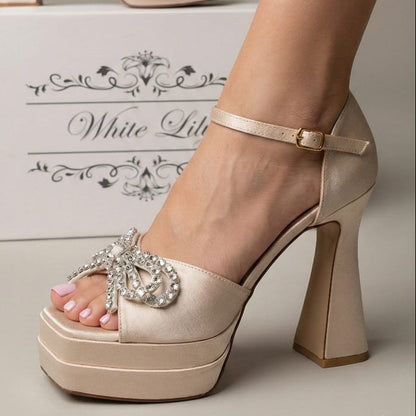 champagne shimmer platform high heel shoe with a crystal bow embellishment and ankle strap